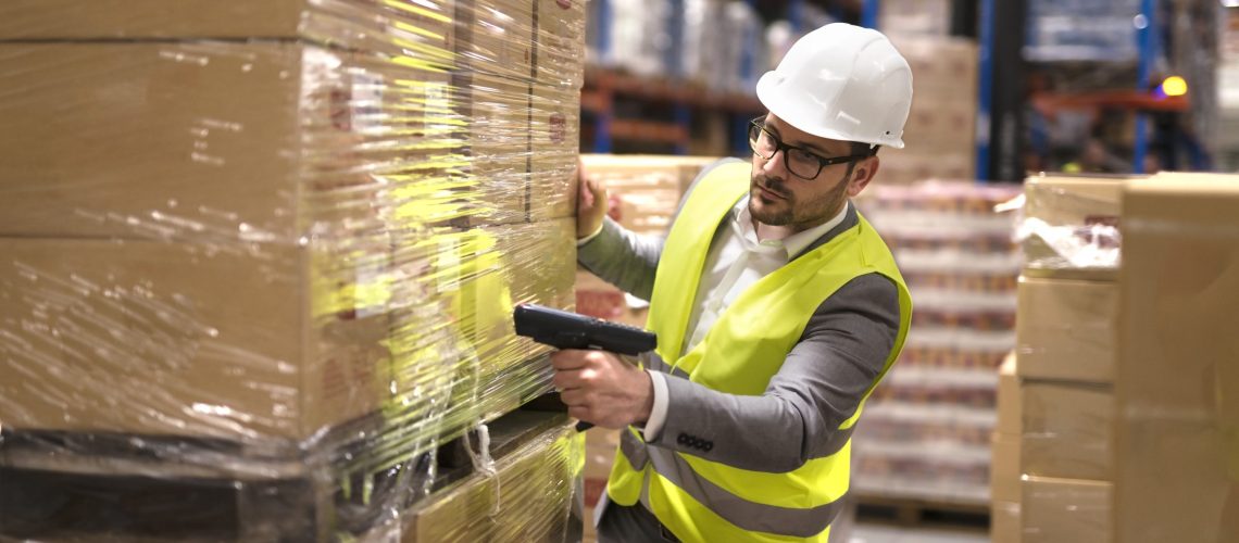 male-warehouse-worker-using-bar-code-scanner-analyze-newly-arrived-goods-further-placement-storage-department (1)